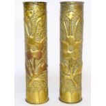 An impressive matching pair of WW1 trench art shell case vases decorated with foliage 34cms high