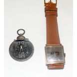 A WW2 Nazi Eastern Front Medal with a wristwatch (not working) with SS and Swastika badges on the