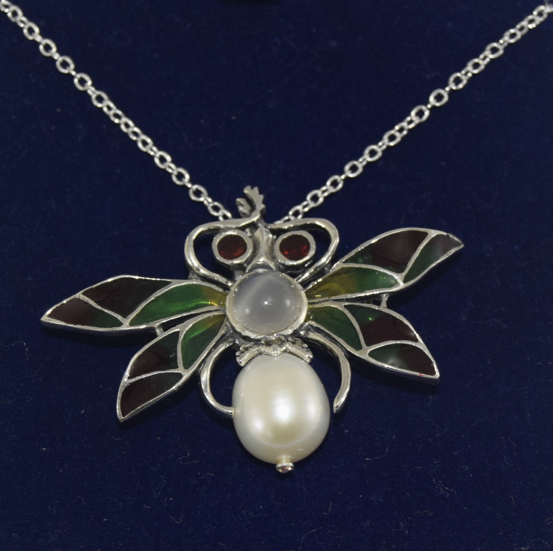 Silver plique a jour pendant necklace in the form of a moth with garnet eyes