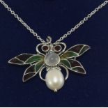 Silver plique a jour pendant necklace in the form of a moth with garnet eyes