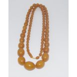 Set of Amber coloured beads of graduated sizes with a twist joiner