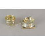 Silver tea strainer with a silver waste bowl full h/m