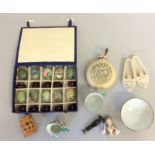 Collection of curios to include painted jade eggs soap stone slippers muff pocket warmer