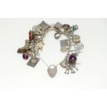 Silver charm bracelet and collection of silver charms 24