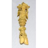 Ivory carved figure of a Chinese man standing on pine nuts