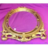 An oval gilt mirror 78cm long