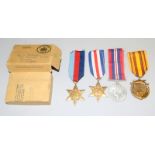A WW2 Medal group of four including the Dunkirk Medal with posting box addressed to Mr N Bramley