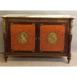 A French style Ormulu marble top side cupboard with gilt figures, two doors and on brass supports