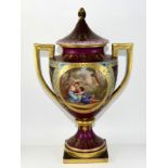 Vienna porcelain 2 handled urn & cover, panels decorated with lovers, on square stand.