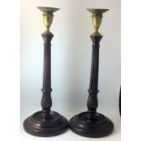 Pair of Georgian weighted mahogany candle sticks