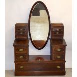 An Edwardian mahogany inlaid dressing chest with jewellery drawers and cupboard compartments on