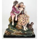 C19th pottery figure of 2 lovers seated on a rocky outcrop, with goat.