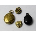 A 9ct yellow gold heart shaped locket, another inset with enamel, a bog oak locket and another