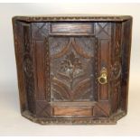 A Victorian carved corner cabinet