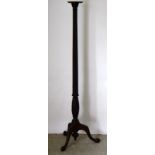 A Victorian mahogany Torchere on flute stem and carved base. 175cm tall