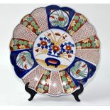 A large Imari charger with wavy rim edge