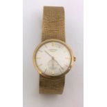 A 9ct gold mens Longines watch with integral strap