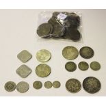 A collection of foreign silver and base metal coins, including a USA half-dollar 1862, two five