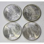 Four USA silver dollars, comprising two Morgan Issue 1886 and Peace Issue 1922 and 1923.