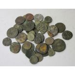 Thirty-four mostly ancient bronze coins, including Roman and Greek issues.