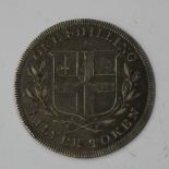 A Charing Cross silver one shilling token.