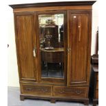 A Victorian mahogany wardrobe, the moulded pediment above a central mirror flanked by crossbanded