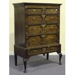 An 18th Century and later oak chest-on-stand with applied geometric mouldings, fitted with short and