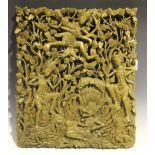 An Indonesian carved softwood panel depicting mythological figures within a foliate pierced