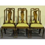 A set of six 18th Century walnut dining chairs, the vase shaped splat backs inlaid with panels