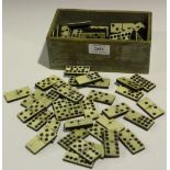 A collection of bone and ebony dominoes.