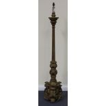 A late 19th/early 20th Century gilt painted composition lamp standard with overall scrolling and