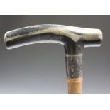 A George V bamboo walking stick with carved rhinoceros/rhino horn handle and silver collar,