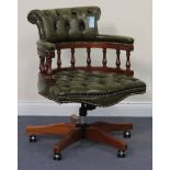 A modern reproduction revolving desk chair, upholstered in buttoned green leather, on reeded legs