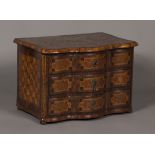 An 18th Century Continental walnut and parquetry inlaid table top chest, the hinged lid of