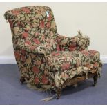 A Victorian walnut framed armchair by Howard & Sons, the shaped button back above a sprung seat,