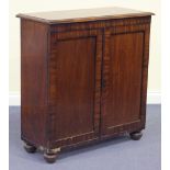 A Victorian mahogany side cabinet, fitted with a pair of panelled doors, on turned bun feet,