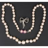 A single row necklace of graduated cultured pearls, on a white gold, ruby and cultured pearl twin