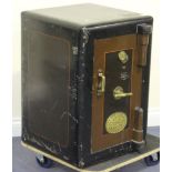 A late Victorian black painted cast iron safe, bearing oval gilt plaque marked 'Fire Resisting Safe,