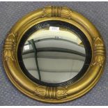 A Regency gilt painted convex wall mirror with a circular section and acanthus leaf frame,