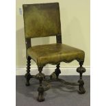 A late 19th Century Charles I style oak chair, the seat and back upholstered in leather, on turned