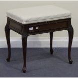 An Edwardian mahogany box seat piano stool, the upholstered top raised on carved cabriole legs,