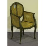 A 20th Century Louis XVI style green dragged bergère armchair with caned seat and back, on