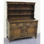 A 20th Century Jacobean Revival oak dresser, the shelf back above two frieze drawers and