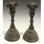 A pair of Victorian cast iron doorstops of neoclassical design, each ram's head finial above a