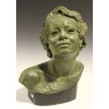 An early 20th Century plaster head and shoulders portrait bust of a lady, with a verdigris finish,