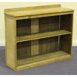 A 20th Century stripped pine open bookcase, the moulded top above an adjustable shelf, on a plinth