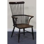 A 19th Century ash and elm comb back Windsor chair, raised on turned legs, width approx 64cm.