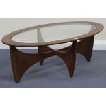 A mid-20th Century G Plan teak oval coffee table, the top inset with a glazed panel, on shaped