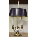 A 20th Century cast brass adjustable student's lamp with tole painted shade and twin lights, on a