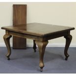 An early 20th Century mahogany extending dining table, the moulded top with an extra leaf, raised on